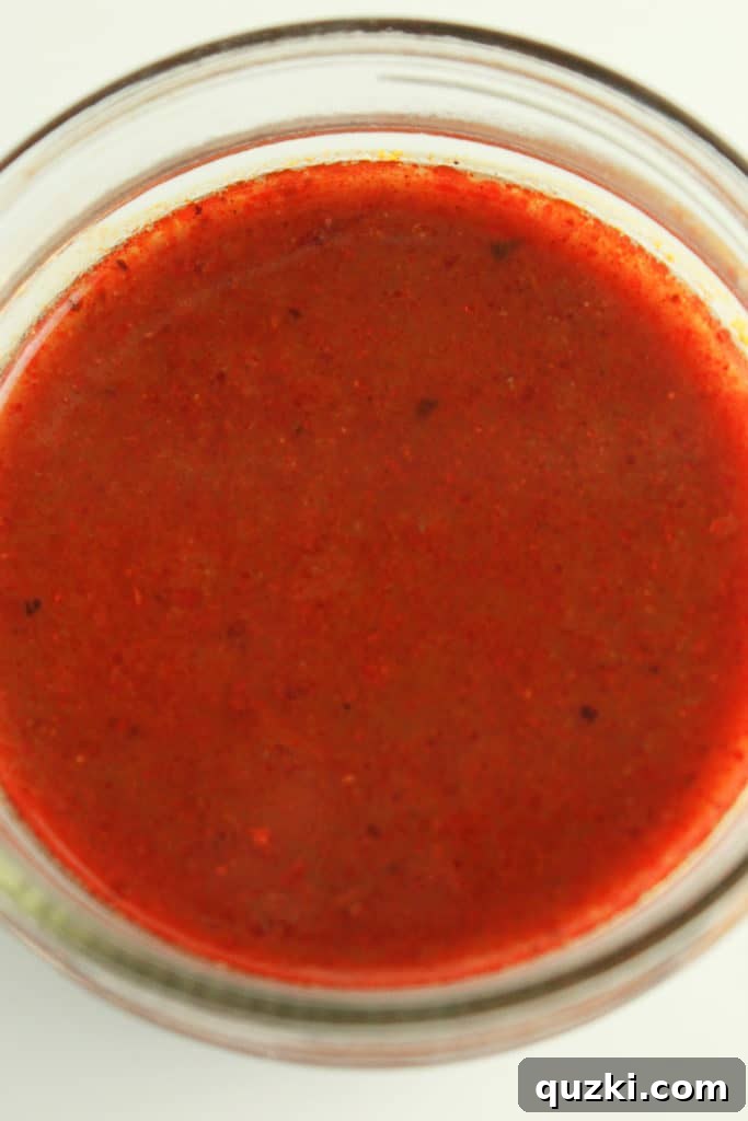 Signature Red Enchilada Sauce 6 Whisking chicken stock into the sauce for smooth consistency