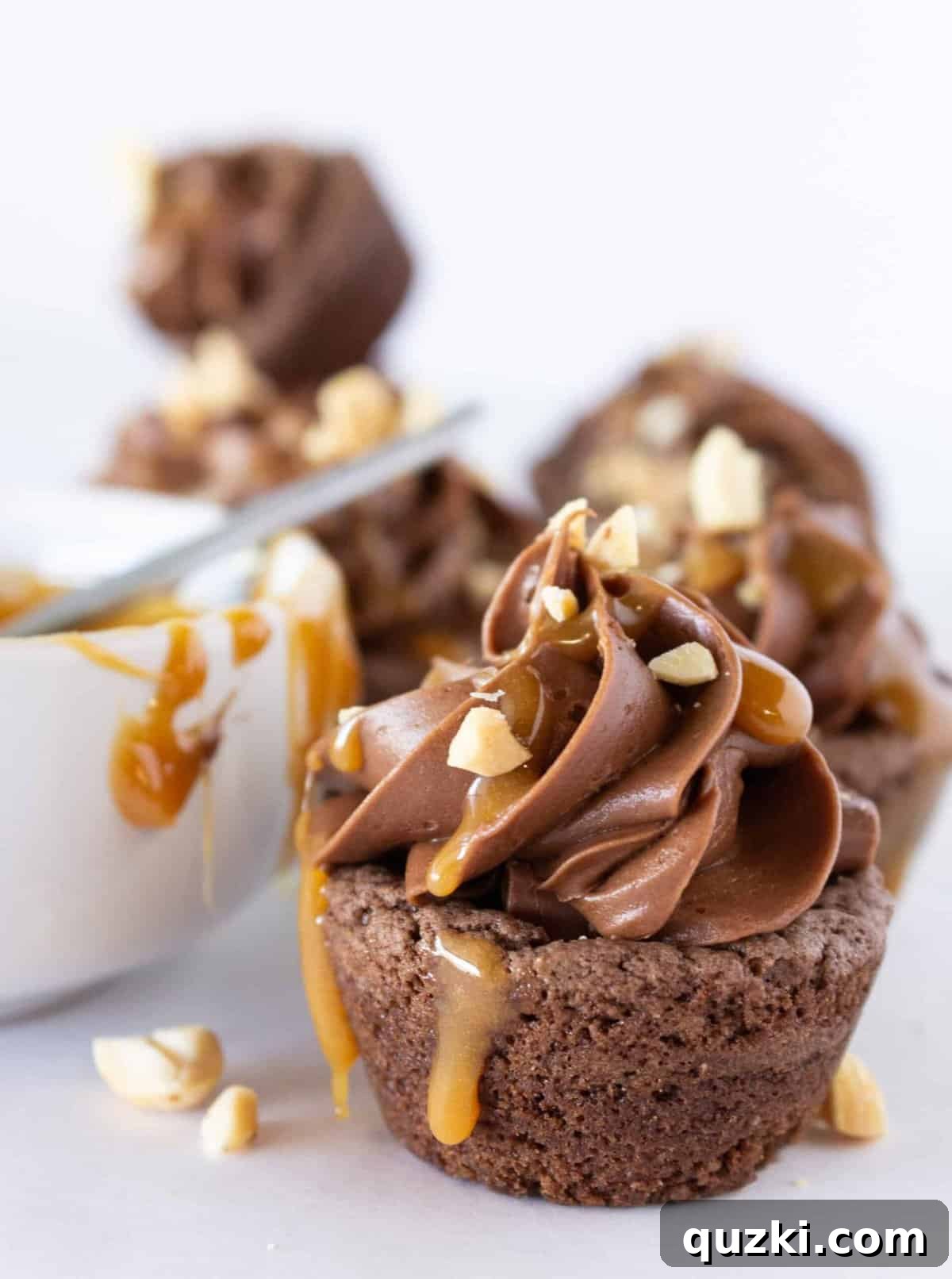 Ultimate Snickers Cookie Cups 11 Adding a rich caramel drizzle as a final decorative and flavorful topping to the Snickers Cookie Cups.