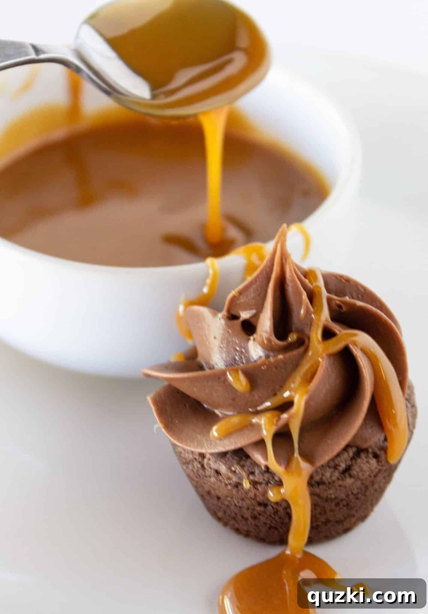 Ultimate Snickers Cookie Cups 9 The final touch: piping frosting, drizzling caramel, and sprinkling peanuts on the Snickers Cookie Cups.