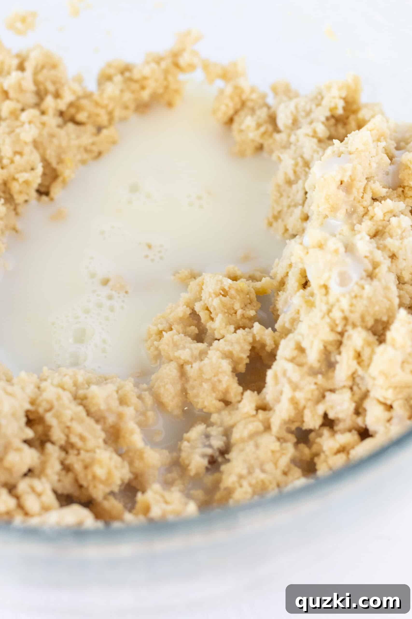 Effortless Lemon Blueberry Sour Cream Crumb Cake 6 Adding milk and sour cream to the lemon blueberry crumb cake batter to achieve a smooth consistency.