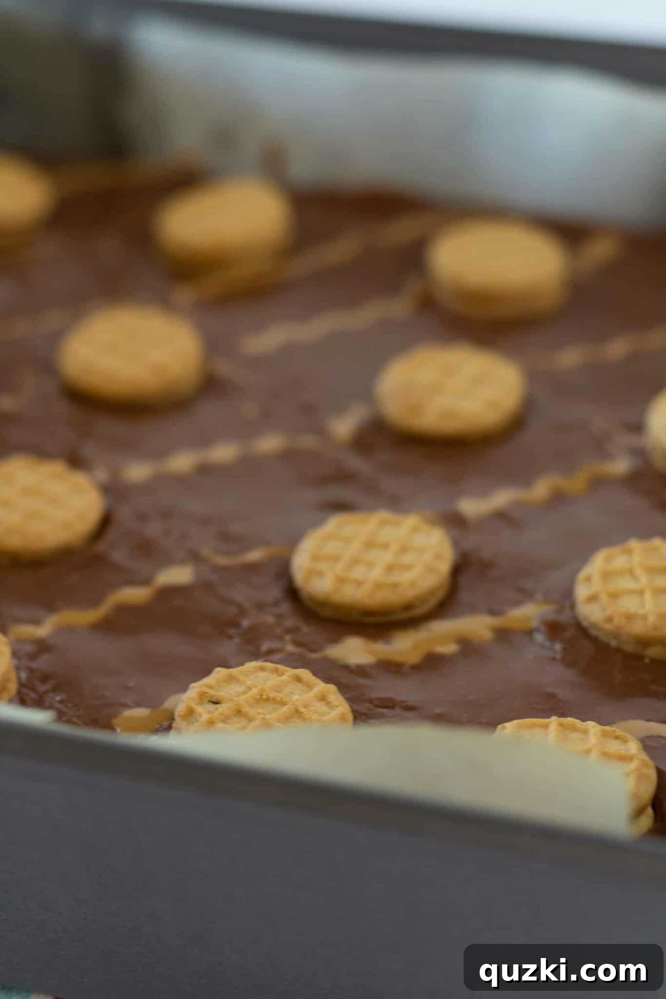 Drizzling melted peanut butter over the chocolate frosting and adding more mini Nutter Butter cookies for garnish.