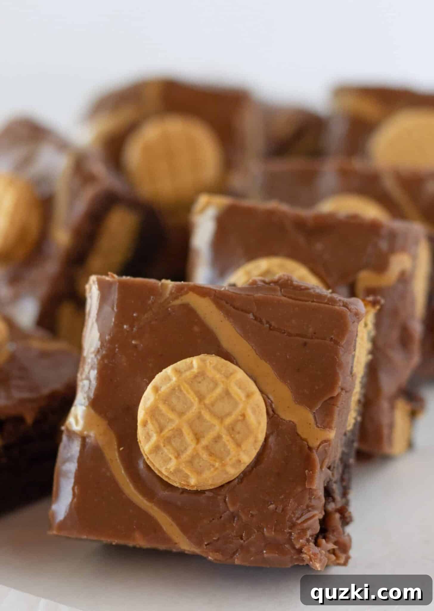 Several Easy Nutter Butter Brownies stacked on top of each other, showing off their layers and deliciousness.