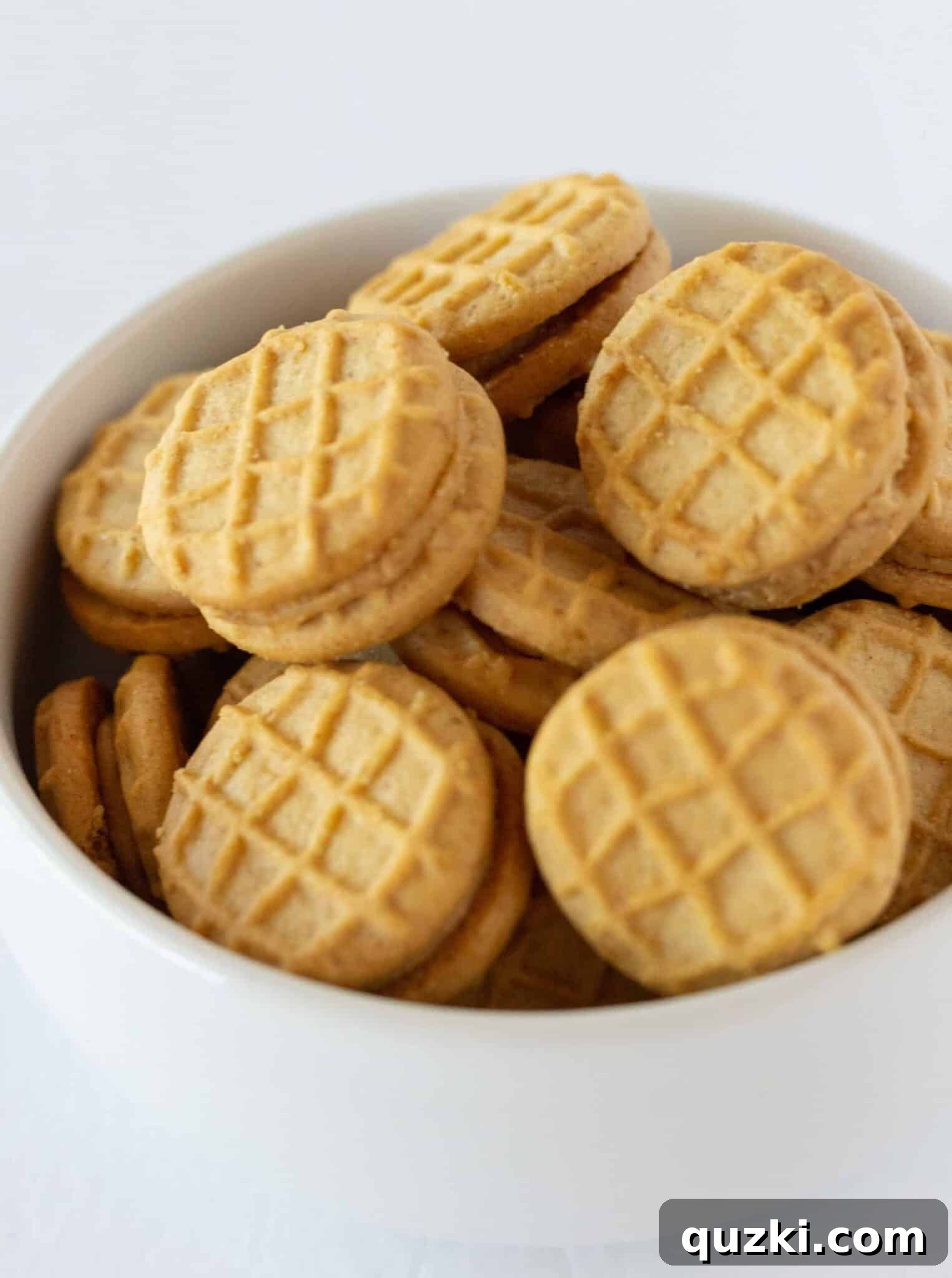Arranging mini Nutter Butter cookies on a cutting board, ready to be incorporated into the brownies.