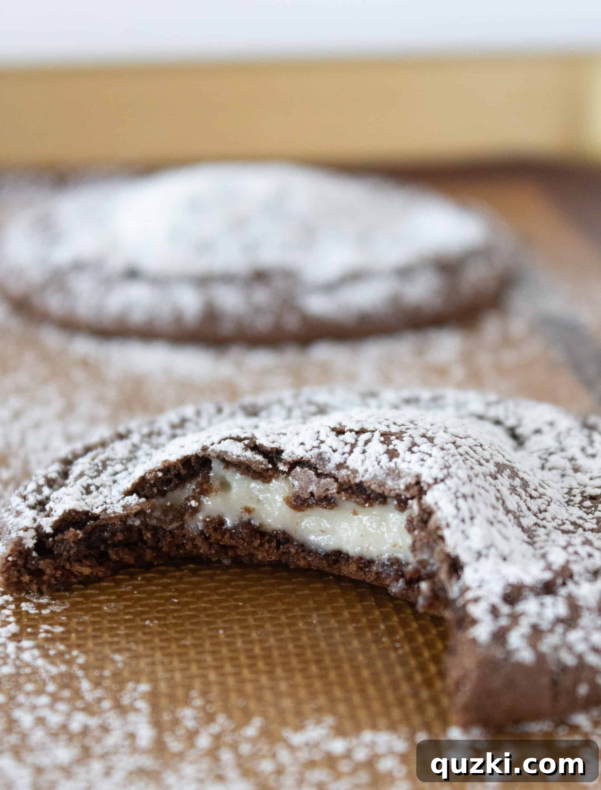 Cake Mix Chocolate Cheesecake Cookies 12 A perfectly cooled Chocolate Cheesecake Cookie, dusted with powdered sugar, ready for serving or enjoyment.