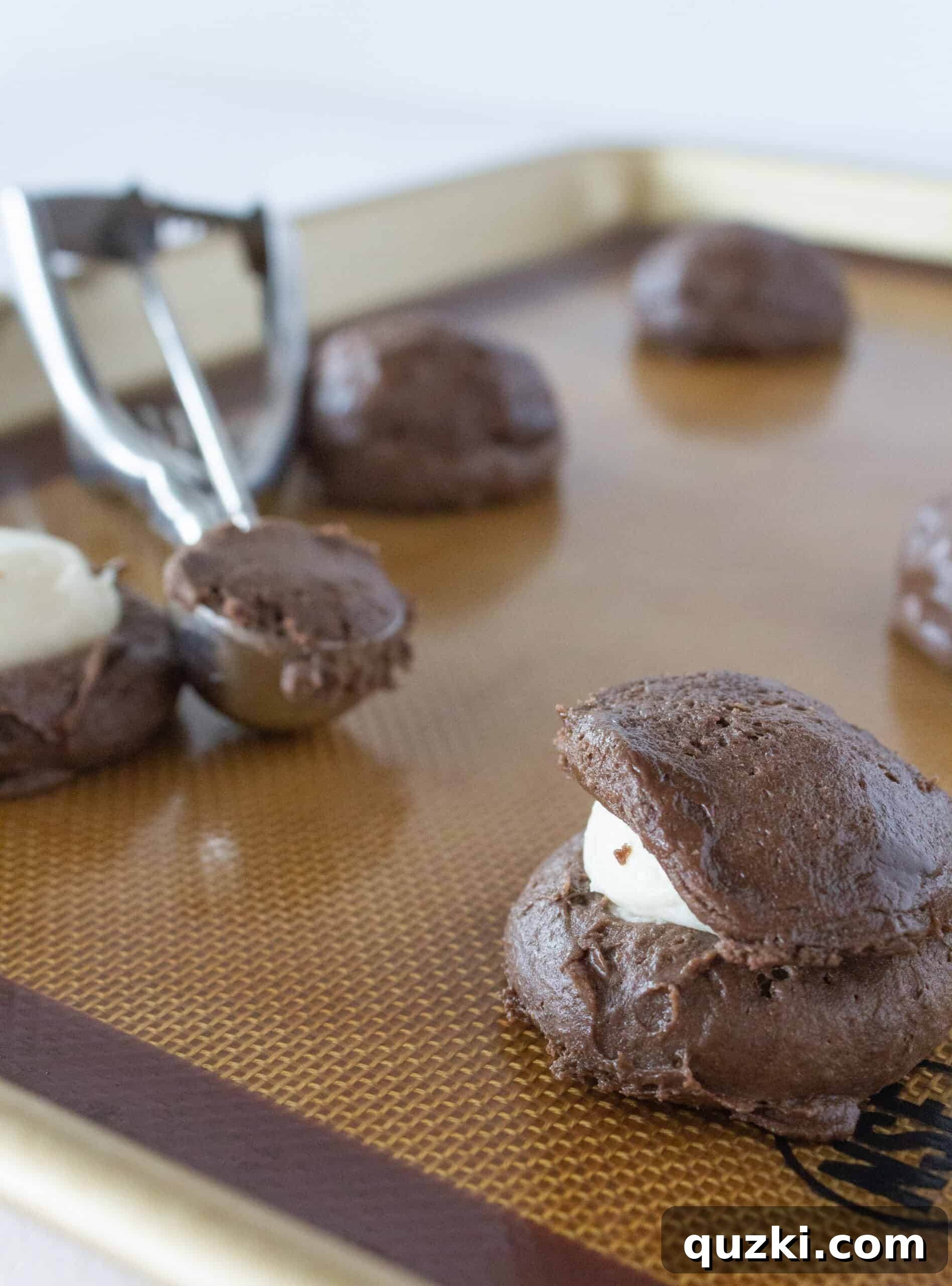 Cake Mix Chocolate Cheesecake Cookies 8 Adding a top layer of chocolate cookie dough to seal the cheesecake filling inside the cookie for a seamless finish.