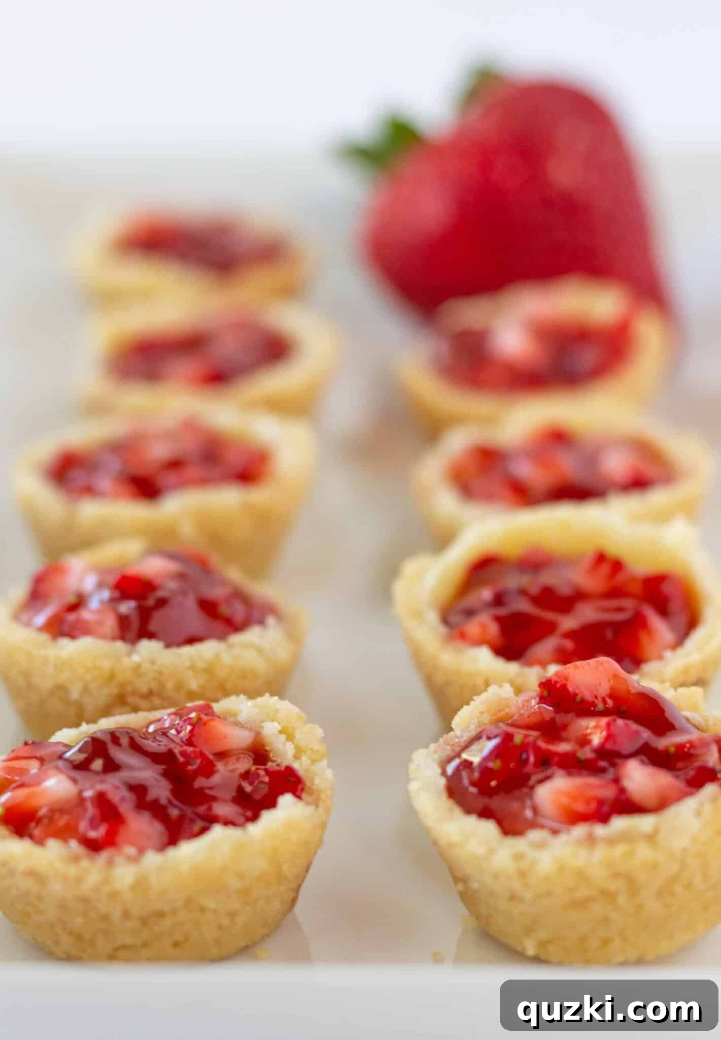Decadent Strawberry Cream Cheese Pastries 14 A complete tray of Strawberry Cream Cheese Pastry Bites, perfectly topped and ready to be served at a gathering.