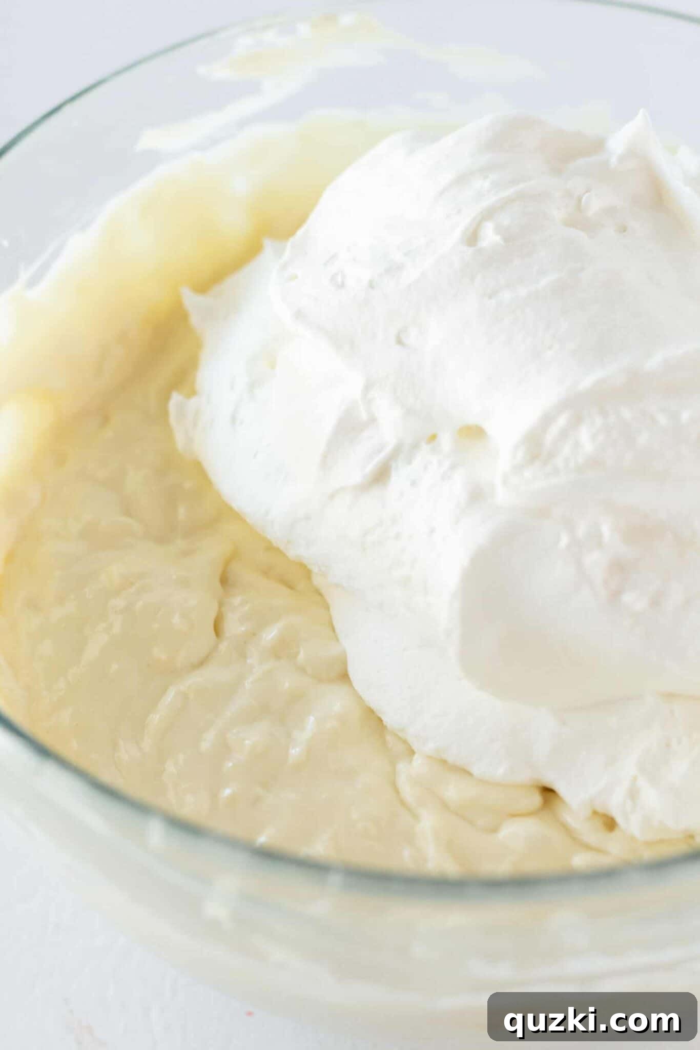 Island Escape No-Bake Cheesecake 7 Gently folding whipped topping into the rich cream cheese and pineapple mixture, creating the light and airy texture for the no-bake Pina Colada cheesecake.