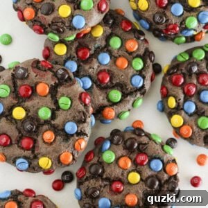 Eight chocolate cake mix M&M cookies on a plate being served, highlighting their vibrant M&M coating.