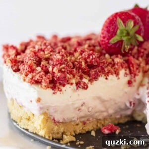 Strawberry Crunch Cheesecake with a golden Oreo crust, ready to be served.
