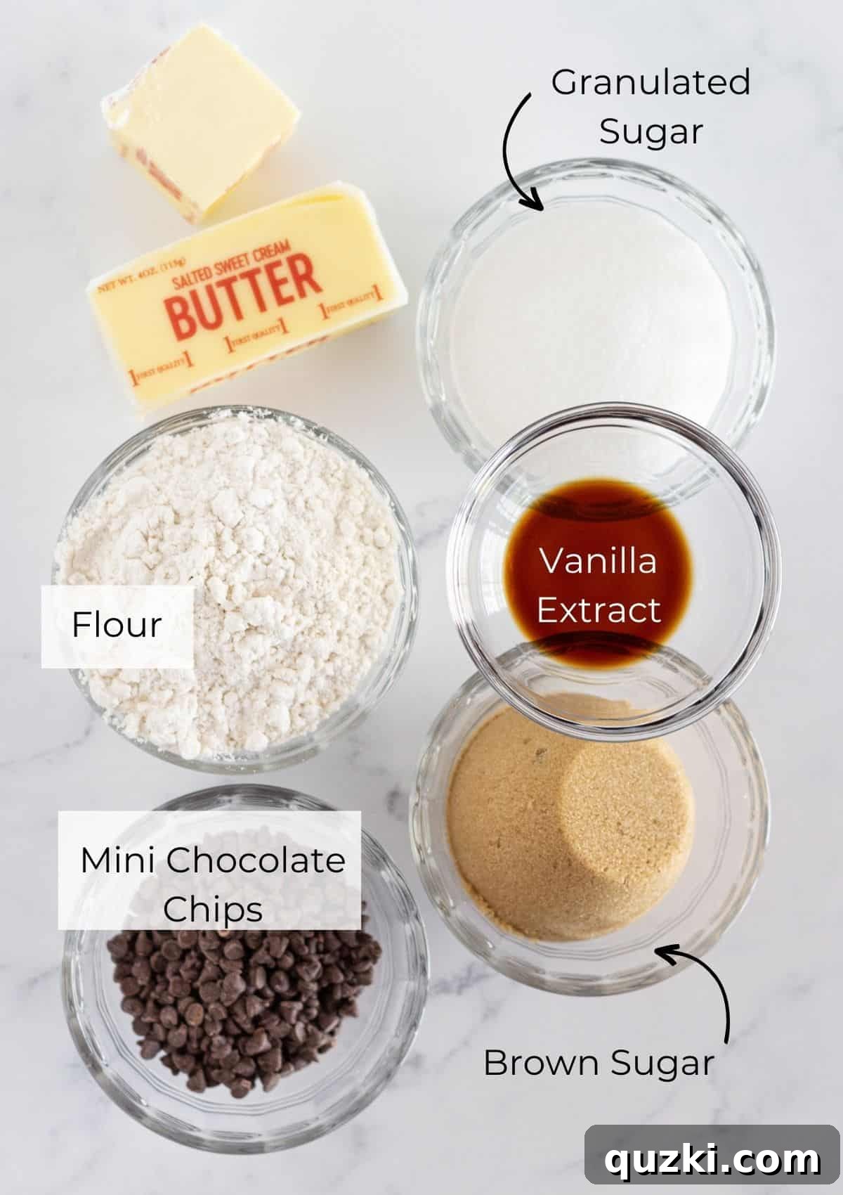 A collection of ingredients laid out, including butter, sugars, flour, and chocolate chips, for making edible cookie dough without eggs.