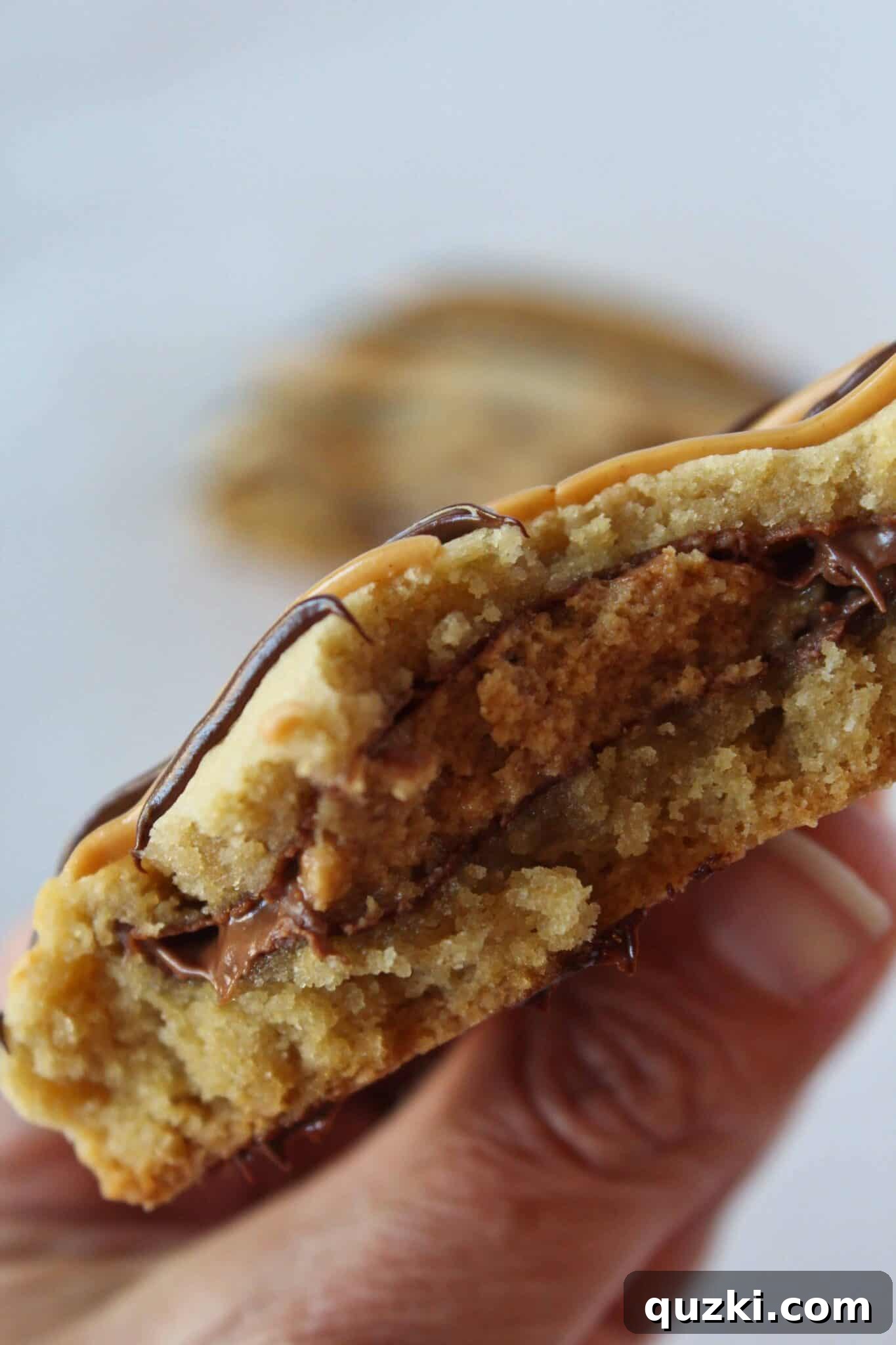 Ultimate Reese's Peanut Butter Cup Cookies 2 Large Reese's Peanut Butter Cup Stuffed Cookie, golden brown and perfectly baked, ready to be enjoyed