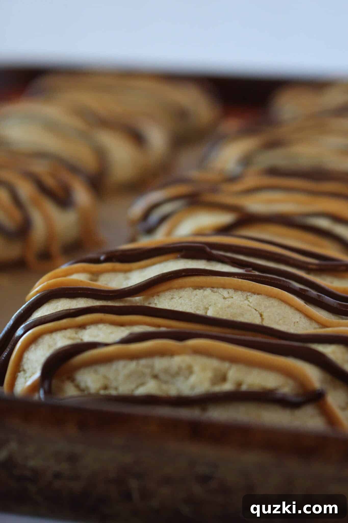 Ultimate Reese's Peanut Butter Cup Cookies 14 Close-up of a Reese's Peanut Butter Cup Stuffed Cookie, showcasing the gooey melted center and sweet drizzle