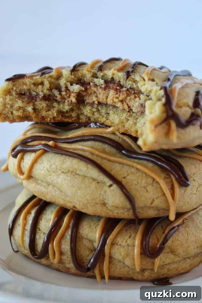 Ultimate Reese's Peanut Butter Cup Cookies 17 A Reese's Peanut Butter Cup Stuffed Cookie cut in half, revealing the perfectly melted peanut butter cup inside