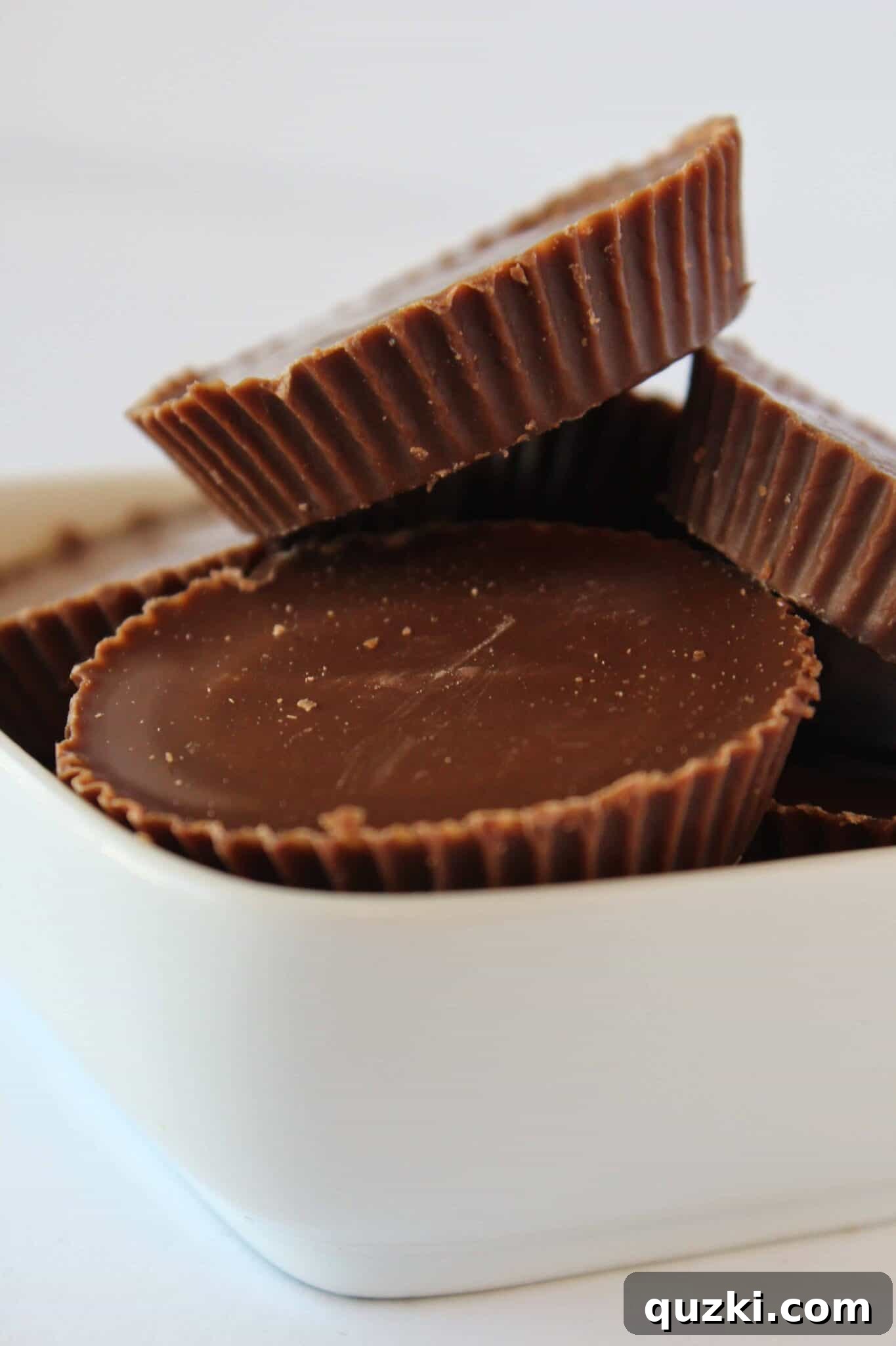 Ultimate Reese's Peanut Butter Cup Cookies 9 Unwrapped, regular-sized Reese's Peanut Butter Cups waiting to be stuffed into delicious cookies