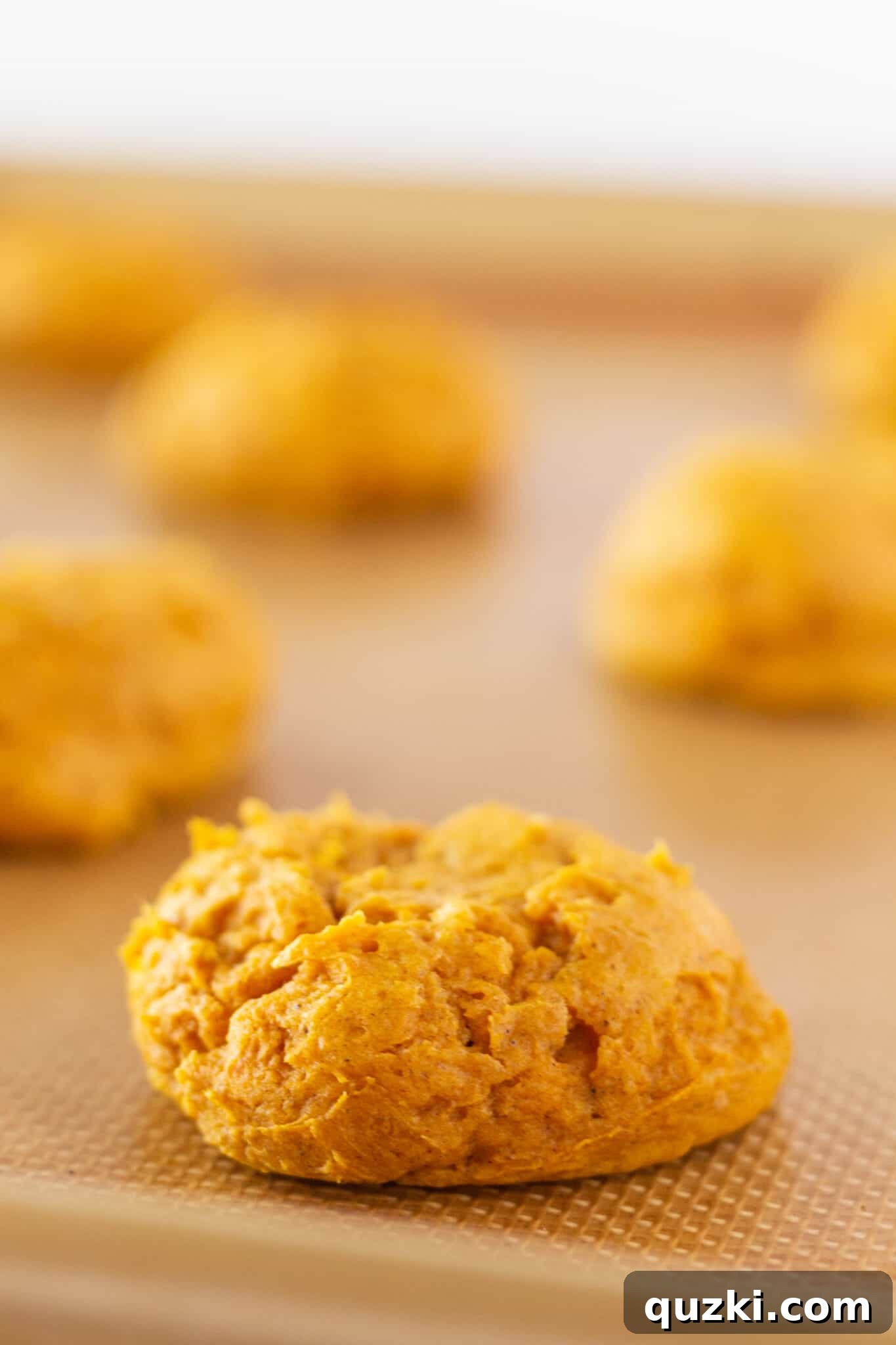 Baked Pumpkin Cream Cheese Cookies cooling on a wire rack, before dusting with powdered sugar.