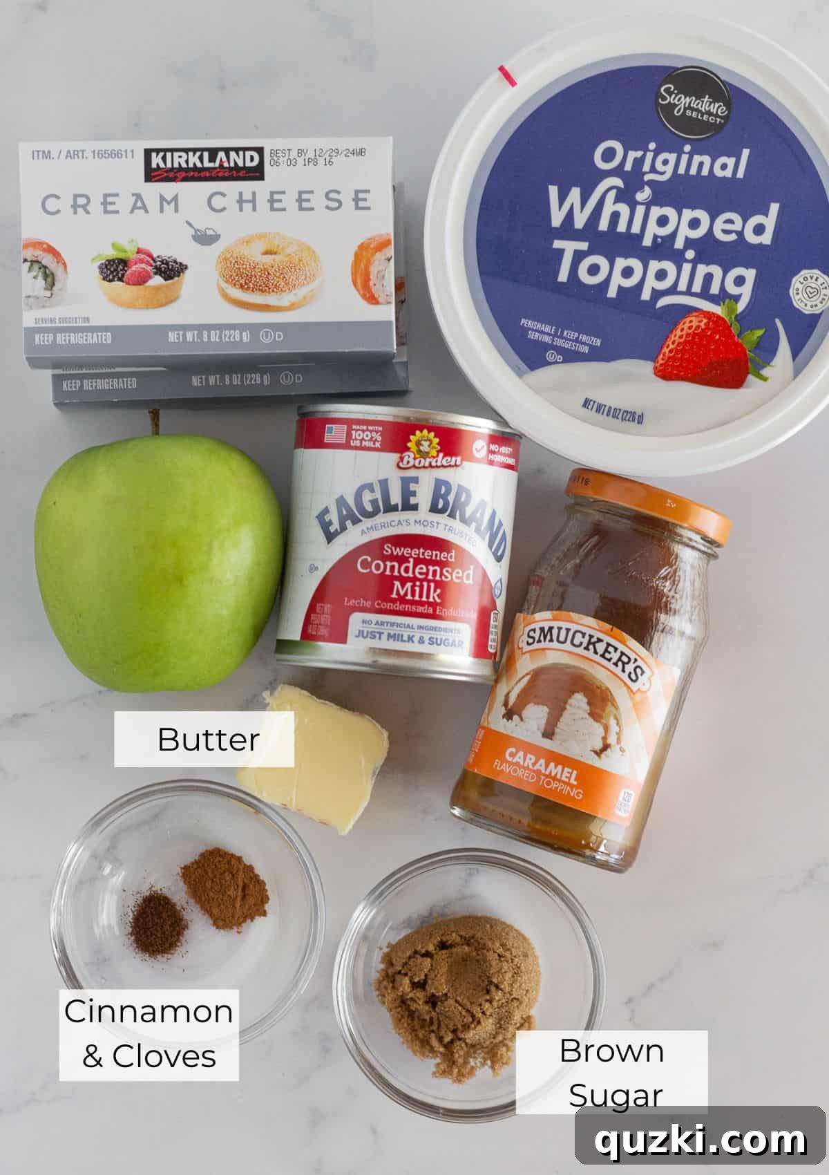 All the essential ingredients laid out for making the caramel apple cheesecake recipe.