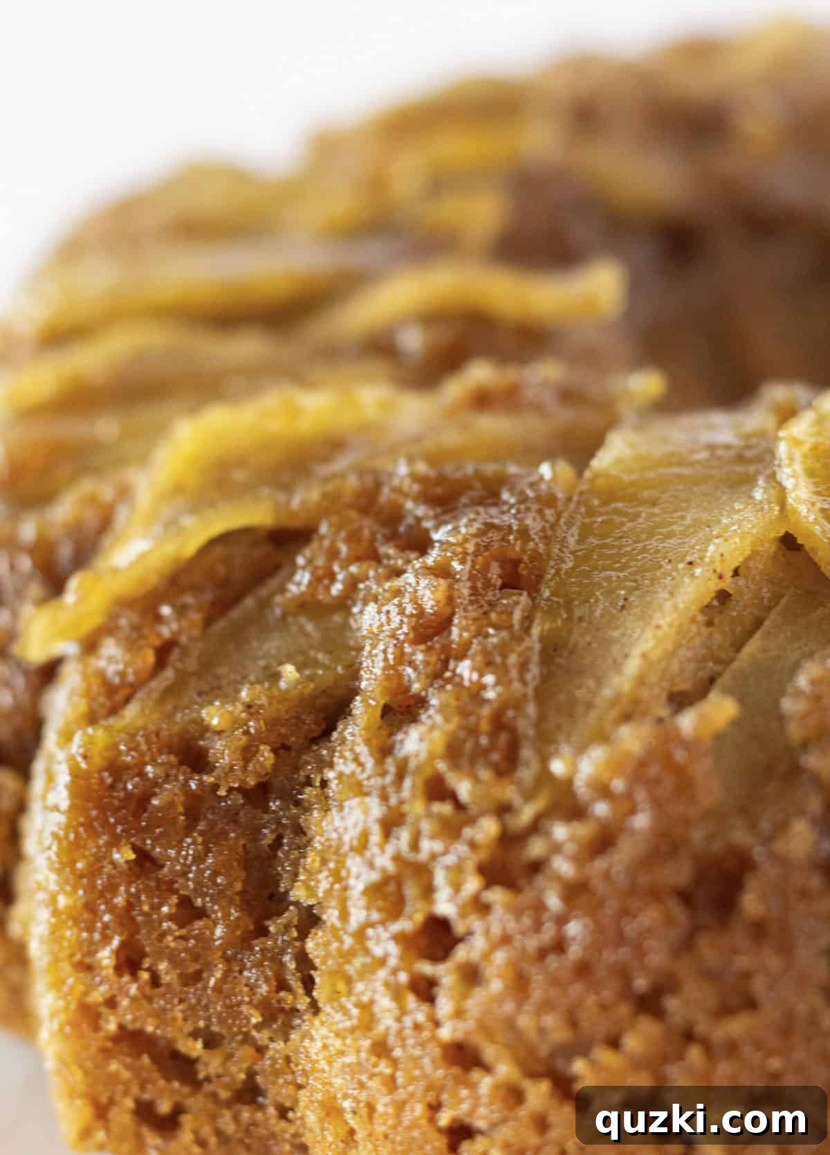 No-Fuss Caramel Apple Upside Down Cake 2 A close-up view of the golden, caramelized apple topping on an Apple Upside Down Cake, showcasing the tender apple slices and rich brown sugar glaze.