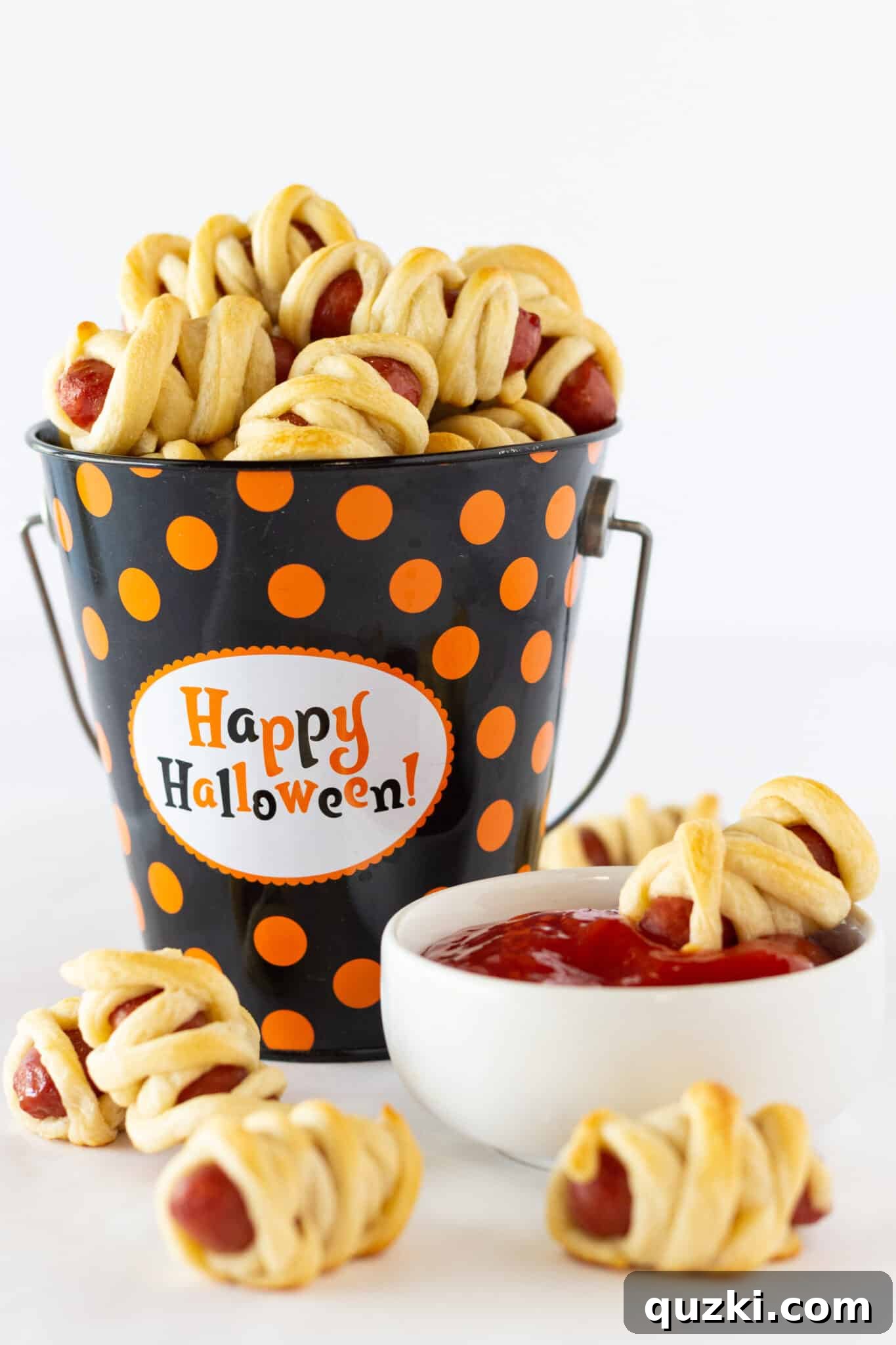 7 Terrifyingly Tasty and Effortless Halloween Treats for Your Party 3 Mini Hot Dog Mummies, a spooky and easy Halloween appetizer made with crescent rolls, perfect for kids and adults at any party.