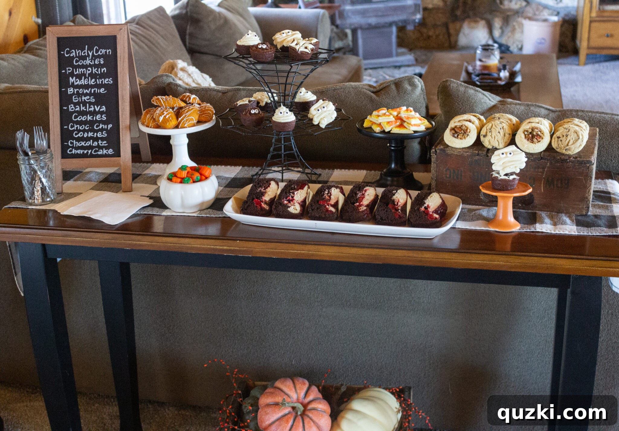 Spooktacular Halloween Dessert Display: 15 Creative and Creepy Treats 2 A completed Halloween Dessert Table, brimming with a variety of festive and delicious treats, decorated with spooky accents like cobwebs and themed serving dishes.