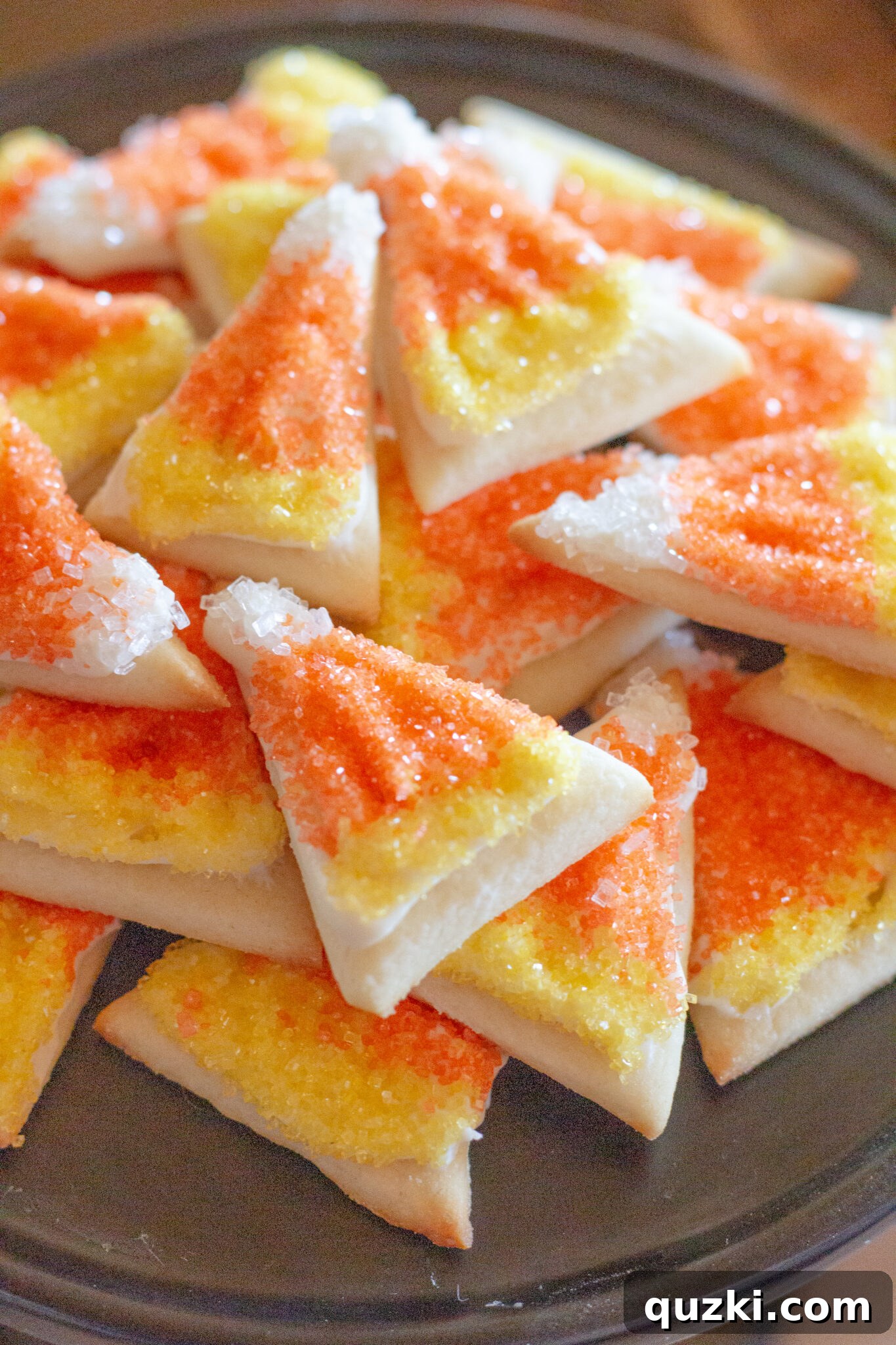 Spooktacular Halloween Dessert Display: 15 Creative and Creepy Treats 3 Candy corn sugar cookies meticulously arranged on a festive tray, showcasing vibrant Halloween colors.