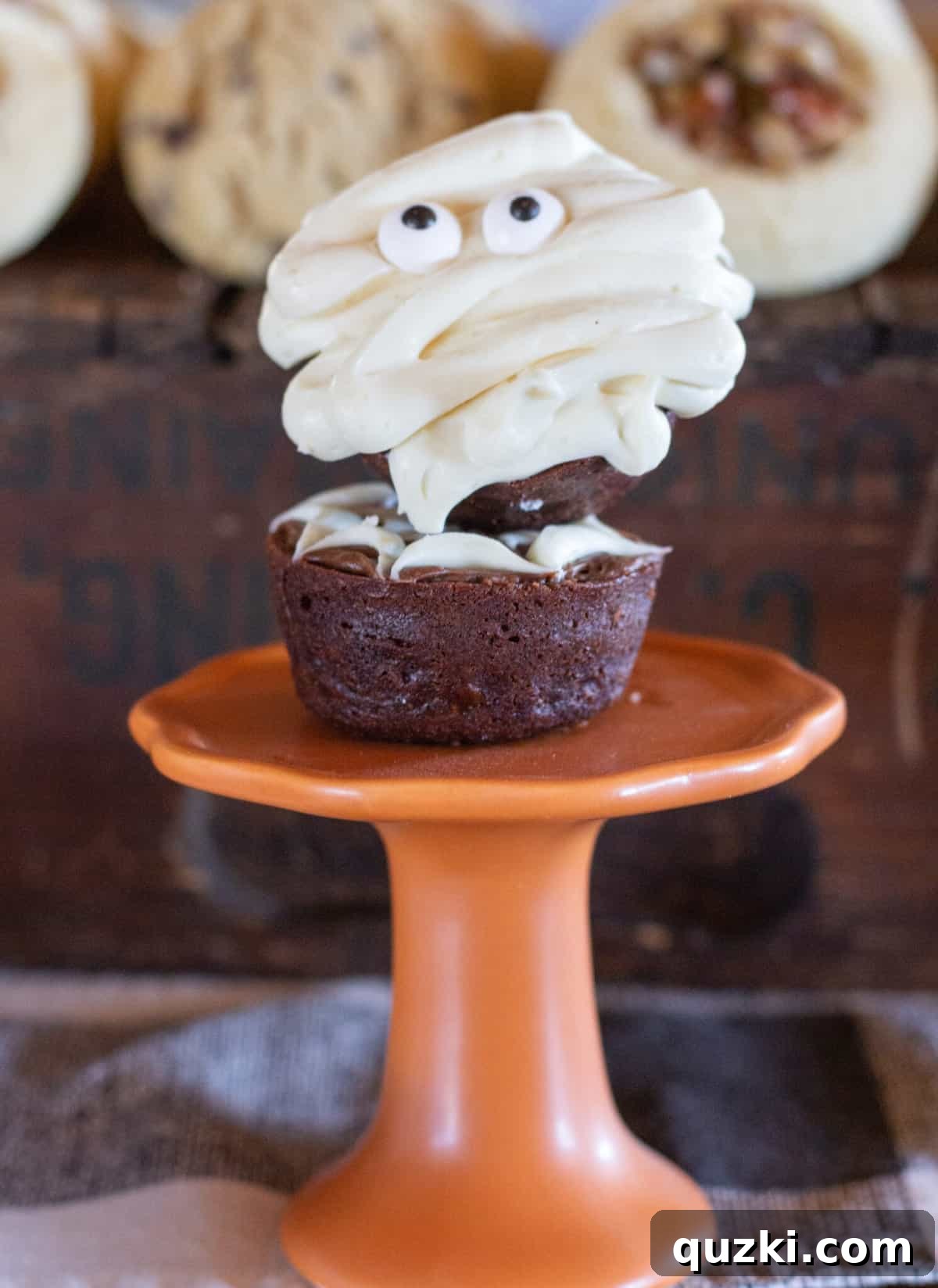 Spooktacular Halloween Dessert Display: 15 Creative and Creepy Treats 10 Two brownie bites stacked neatly on top of each other, presented on a vibrant orange plate, ready to be enjoyed.