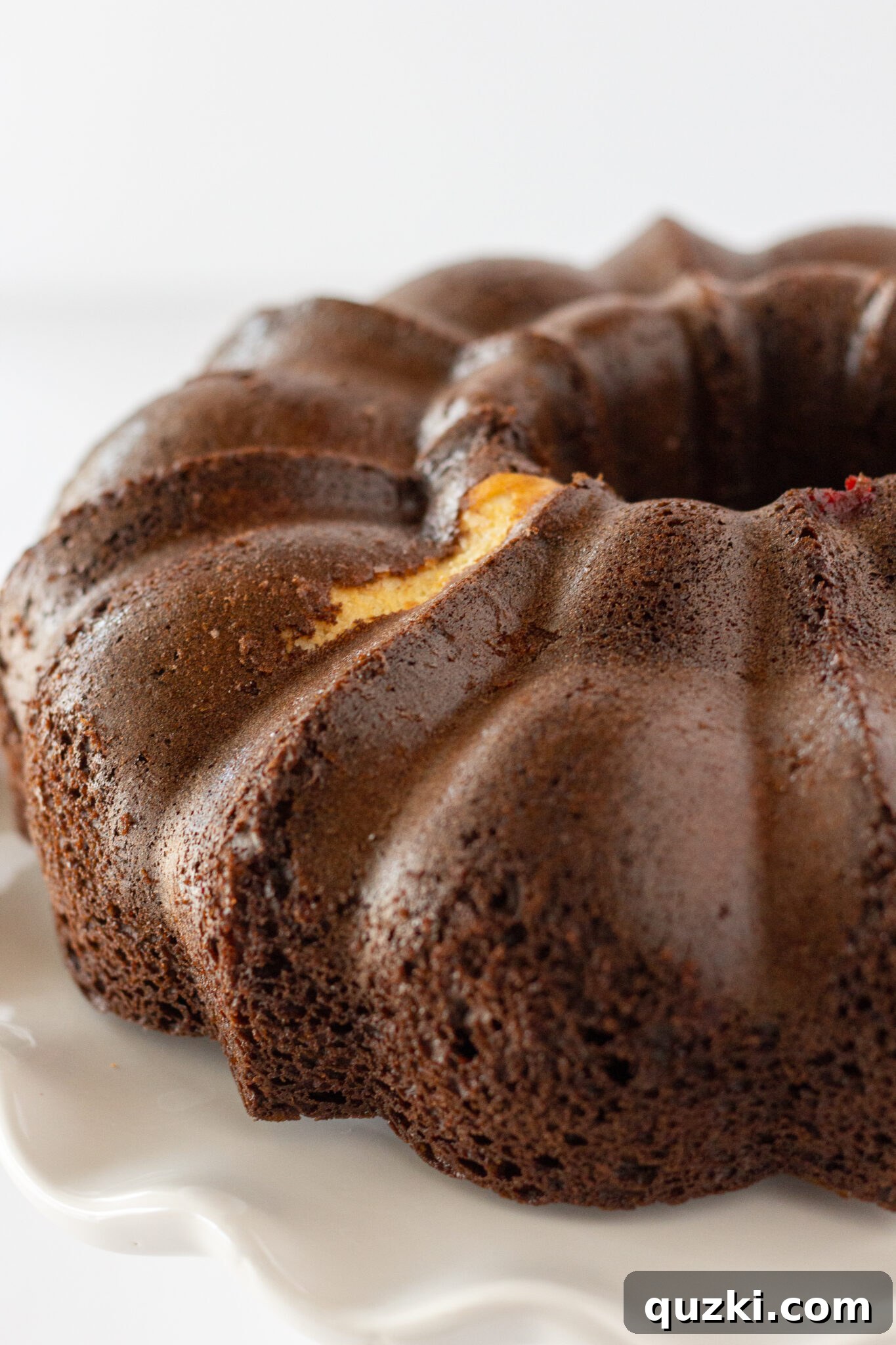 Cherry Cheesecake Chocolate Bundt Cake cooling on a wire rack after being inverted from the pan.