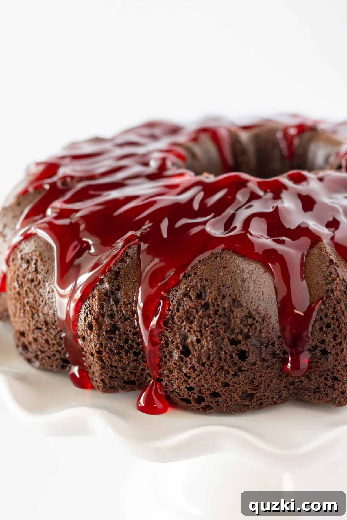 Finished Cherry Cheesecake Chocolate Bundt Cake topped with glossy cherry glaze, ready to be served.