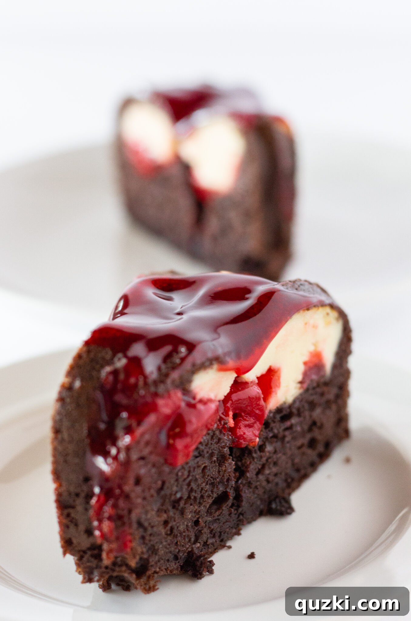 Seven Cherry Cheesecake Chocolate Bundt Cakes lined up, highlighting the vibrant cherry glaze.