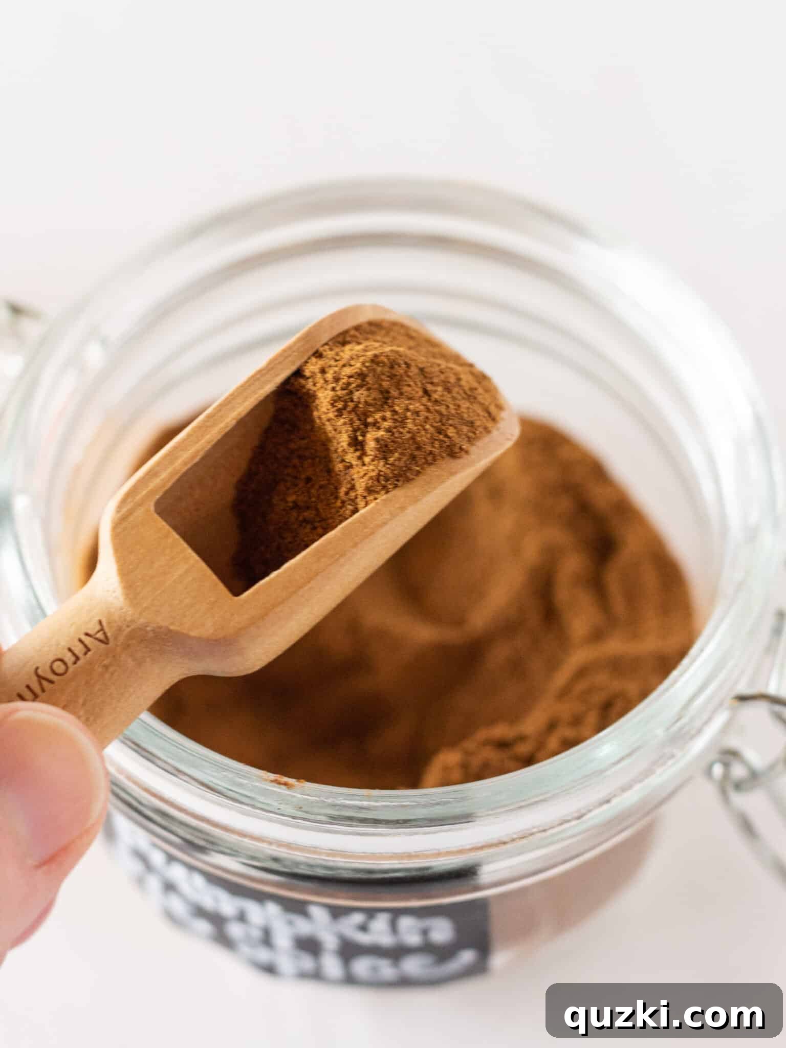 Perfect Homemade Pumpkin Spice 2 Homemade Pumpkin Pie Spice Recipe in a jar with a wooden scoop, ready for use.