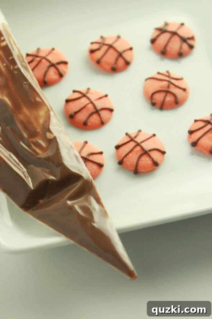 Slam Dunk Cupcake Toppers 6 Overhead view of a cupcake adorned with a basketball topper, ready for a March Madness event.