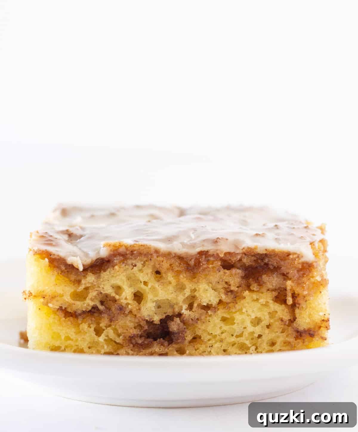 Effortless Cinnamon Roll Cake 6 A perfect slice of the best cinnamon roll cake, showing off its rich swirl and glistening glaze!