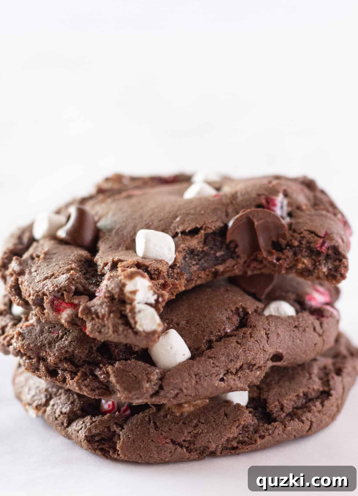 Cake Mix Peppermint Hot Cocoa Cookies 6 Easy Hot Cocoa Peppermint Cookies stacked on each other, showing off their rich texture.