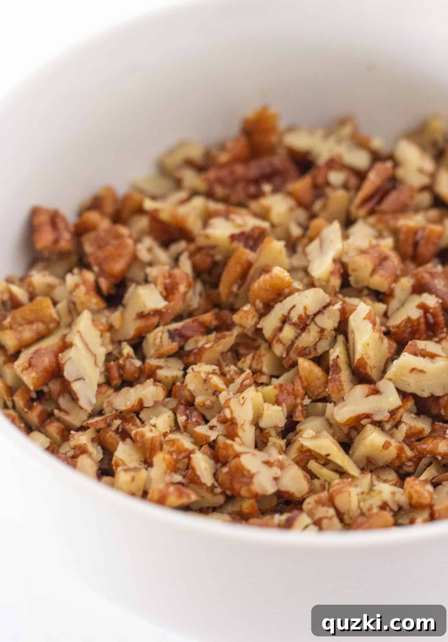 A beautifully presented slice of butter pecan cream pie, highlighting the delectable texture and flavor of buttered pecans in a dessert.