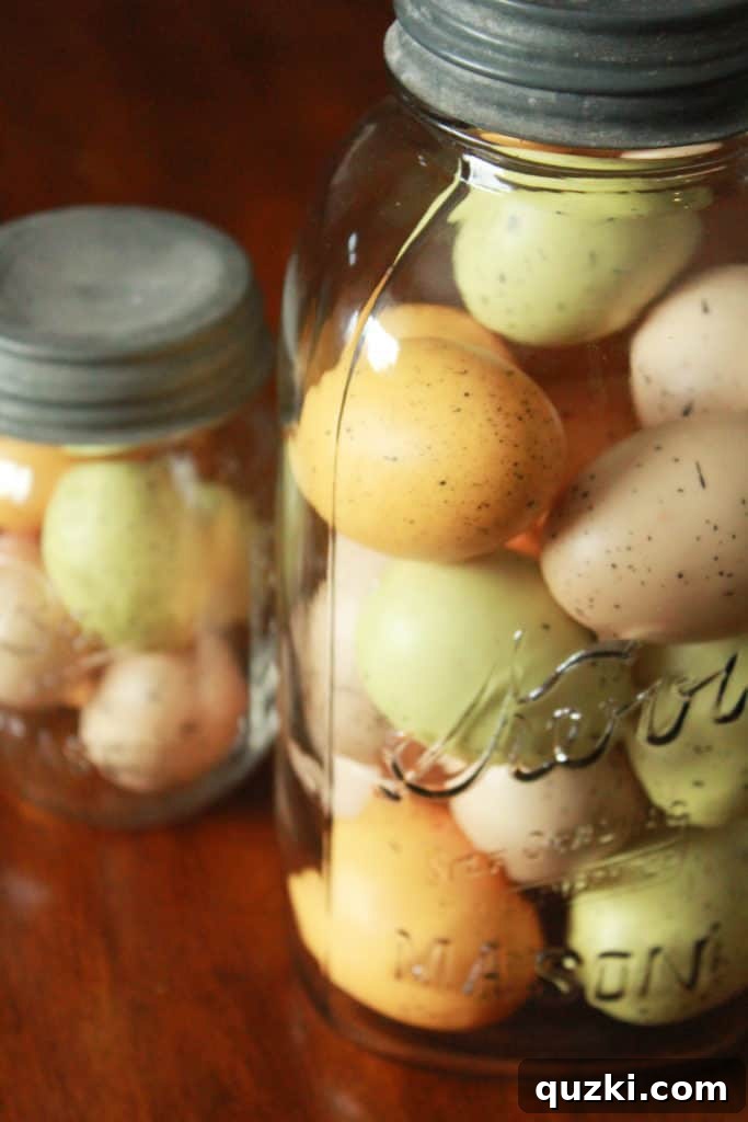 Hop into Easter Decor Ideas 8 Easter decorations on a sideboard or console table, featuring large mason jars filled with speckled eggs, accompanied by a rustic wooden sign, extending the theme beyond the tiered tray.