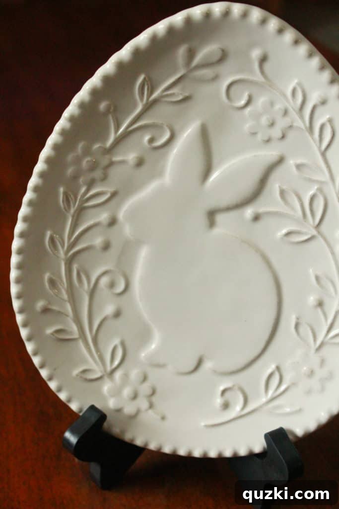 Hop into Easter Decor Ideas 10 A decorative Easter plate with delicate floral patterns and a soft color palette, perfect for adding an inexpensive yet charming holiday touch to your home styling.