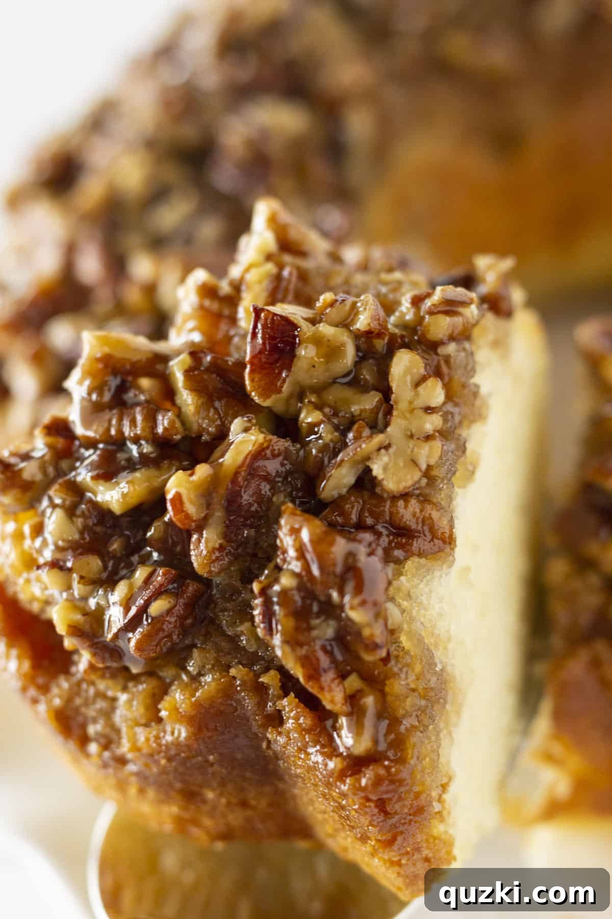 Stunning Christmas Bundt Cakes to Dazzle Your Guests 11 A delectable slice of Pecan Upside Down Cake being served, showcasing its rich, sticky pecan topping.