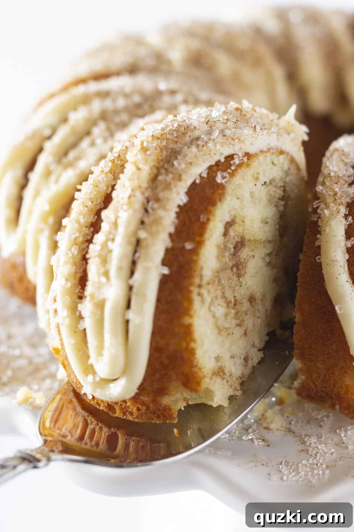 Stunning Christmas Bundt Cakes to Dazzle Your Guests 15 A serving of moist Snickerdoodle Bundt Cake, topped with creamy frosting and a dusting of cinnamon sugar.