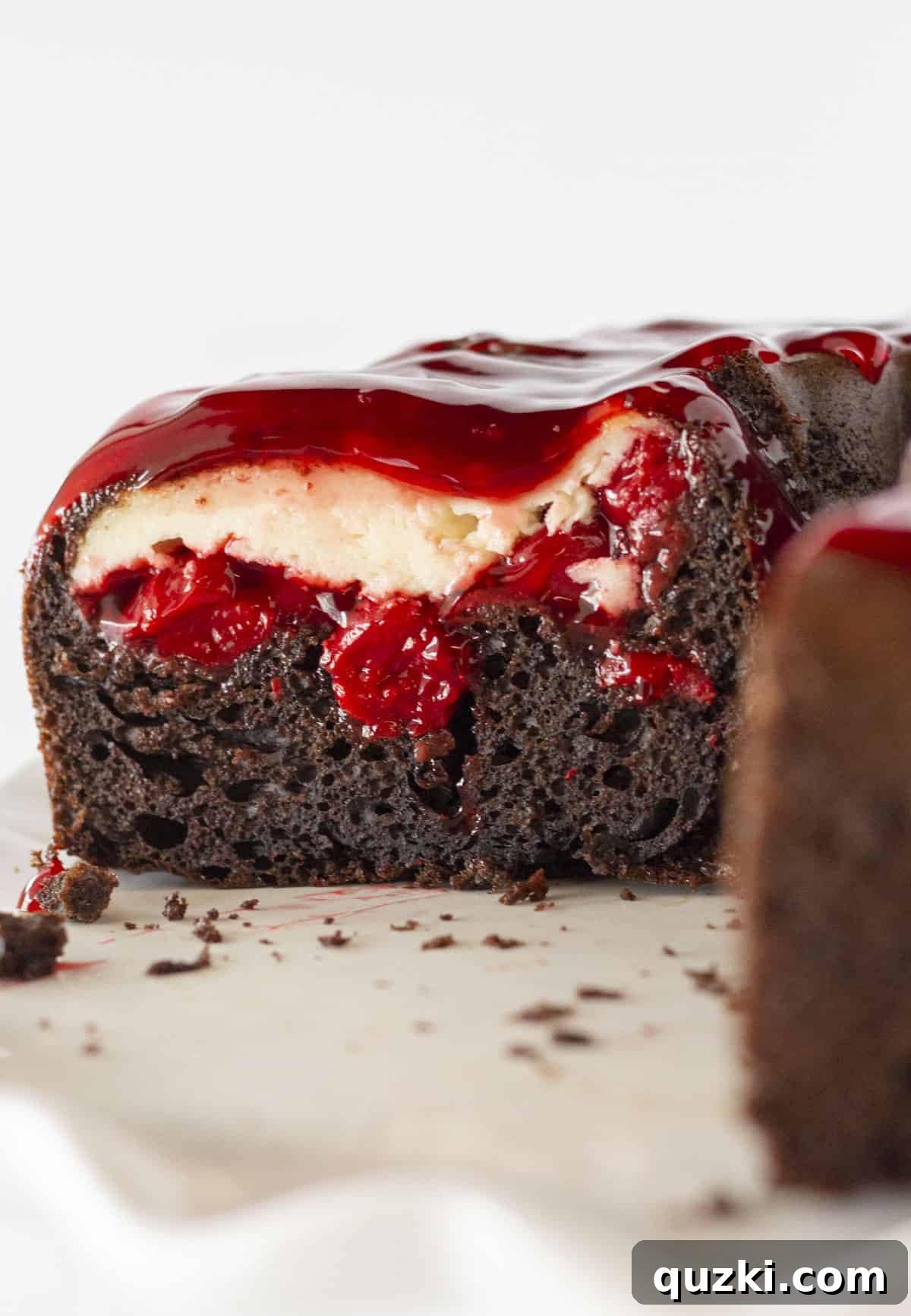 Stunning Christmas Bundt Cakes to Dazzle Your Guests 5 A cross-section of a Chocolate Cherry Cheesecake Bundt Cake, revealing the beautiful swirl of dark chocolate cake and creamy cherry cheesecake filling.