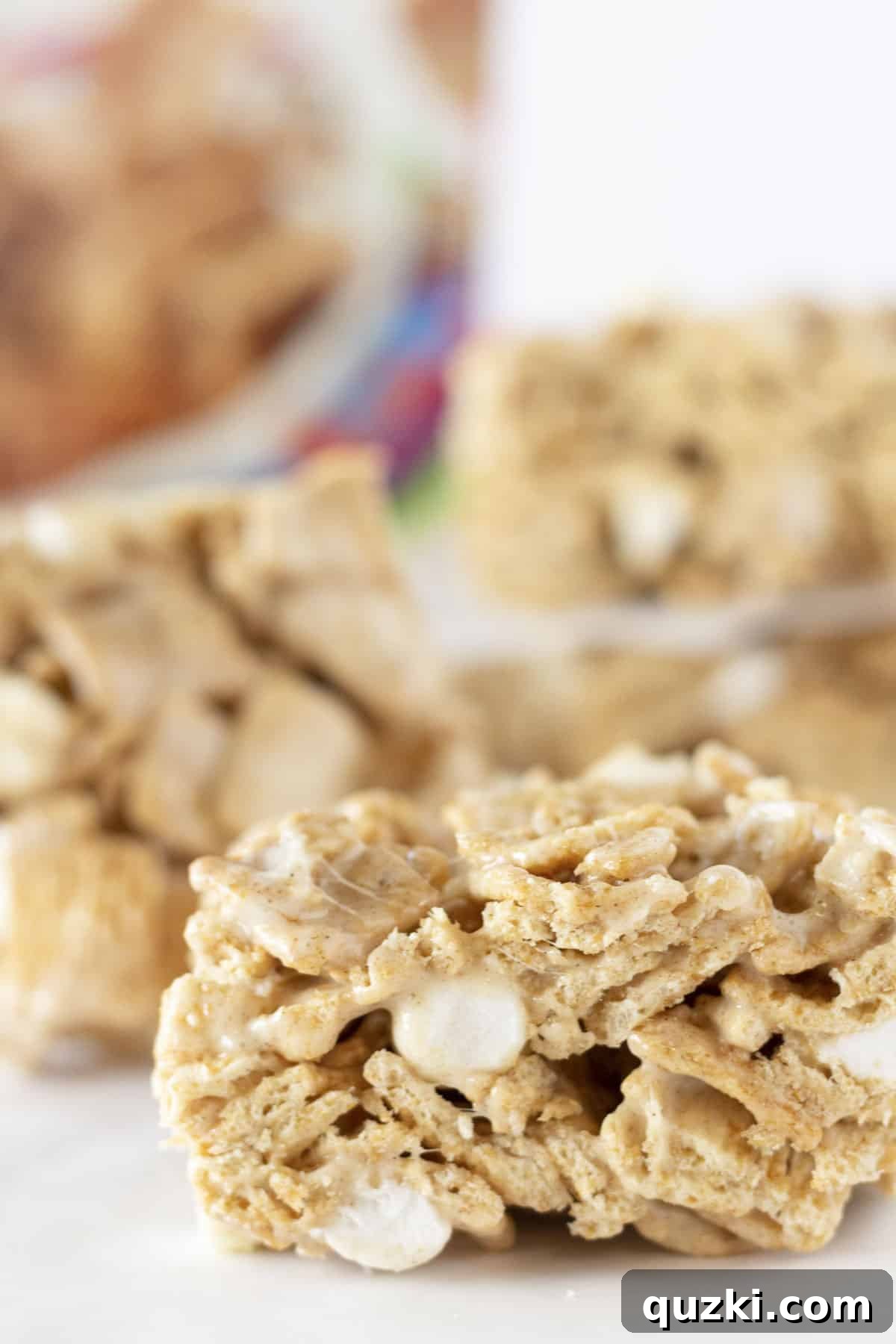 Delicious bars crafted from Cinnamon Toast Crunch cereal, butter, and marshmallows, showcasing their golden, crispy texture, perfect for a quick and easy no-bake Christmas treat.