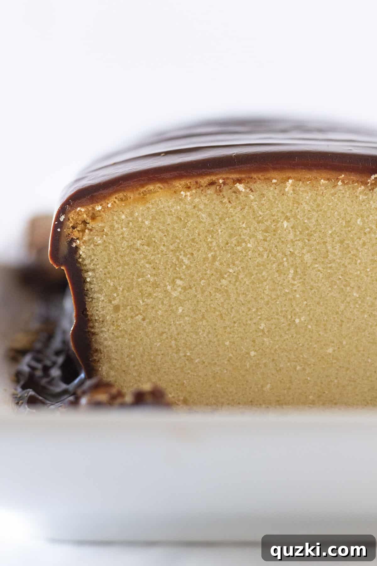 A stunning Twix no-bake cake, meticulously crafted using a frozen pound cake base, generously layered with caramel and chocolate ganache, embodying the essence of the classic candy bar.