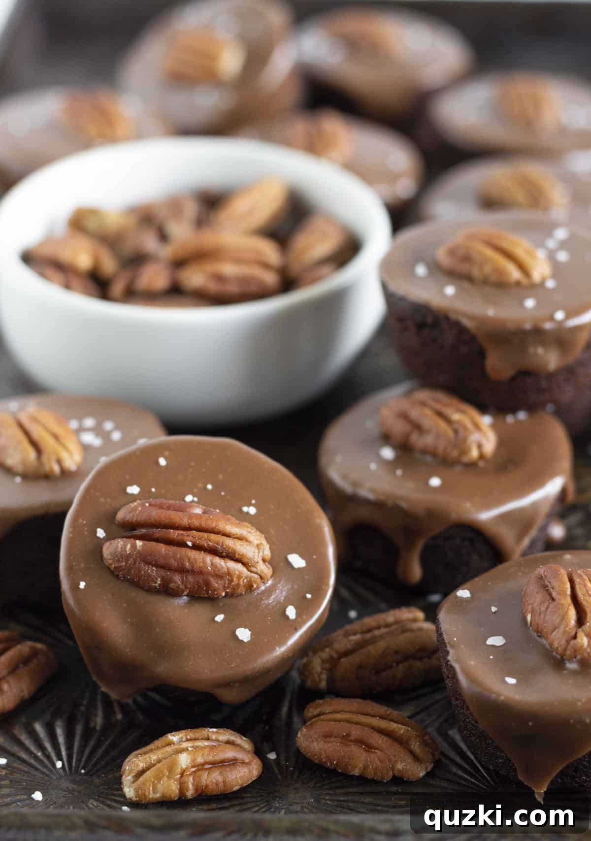 Delectable No-Bake Texas Sheet Cake Bites, crafted from store-bought brownie bites and topped with rich chocolate frosting and crunchy pecans, presented as a quick and easy holiday dessert.
