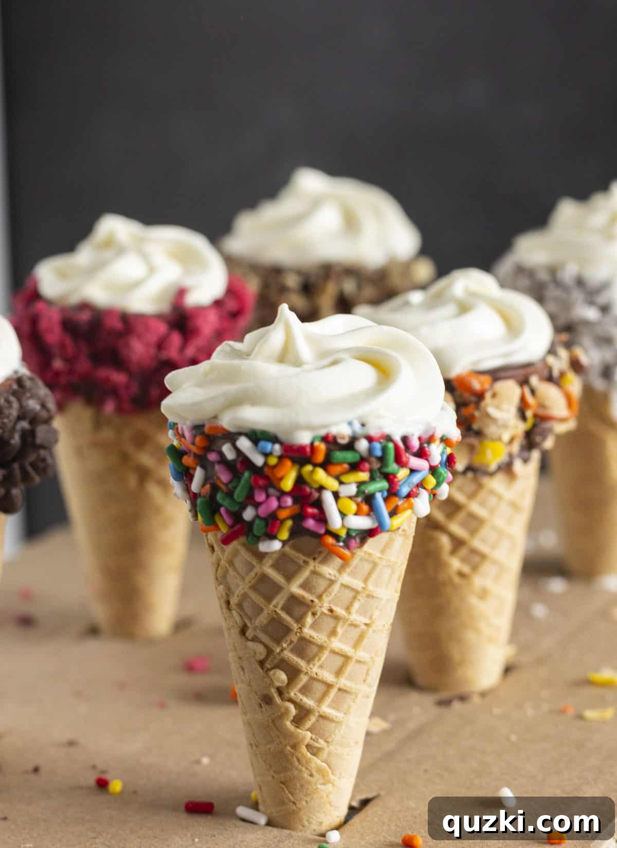 Playful No-Bake Cheesecake Cones, filled with creamy cheesecake and topped with sprinkles, served in sugar cones, offering a fun and portable dessert option for all ages.