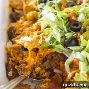 A beautifully served portion of Easy Doritos Casserole with Ground Beef, garnished with fresh toppings.