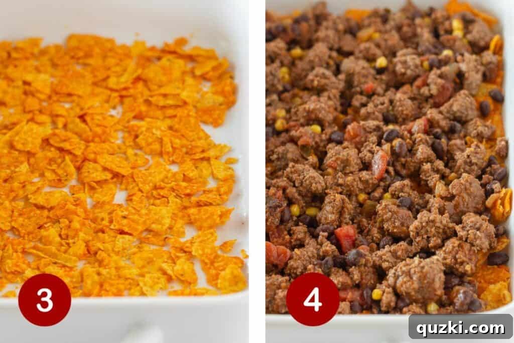 A baking dish with the first layer of crushed Doritos, followed by the ground beef mixture, and topped with shredded cheese.