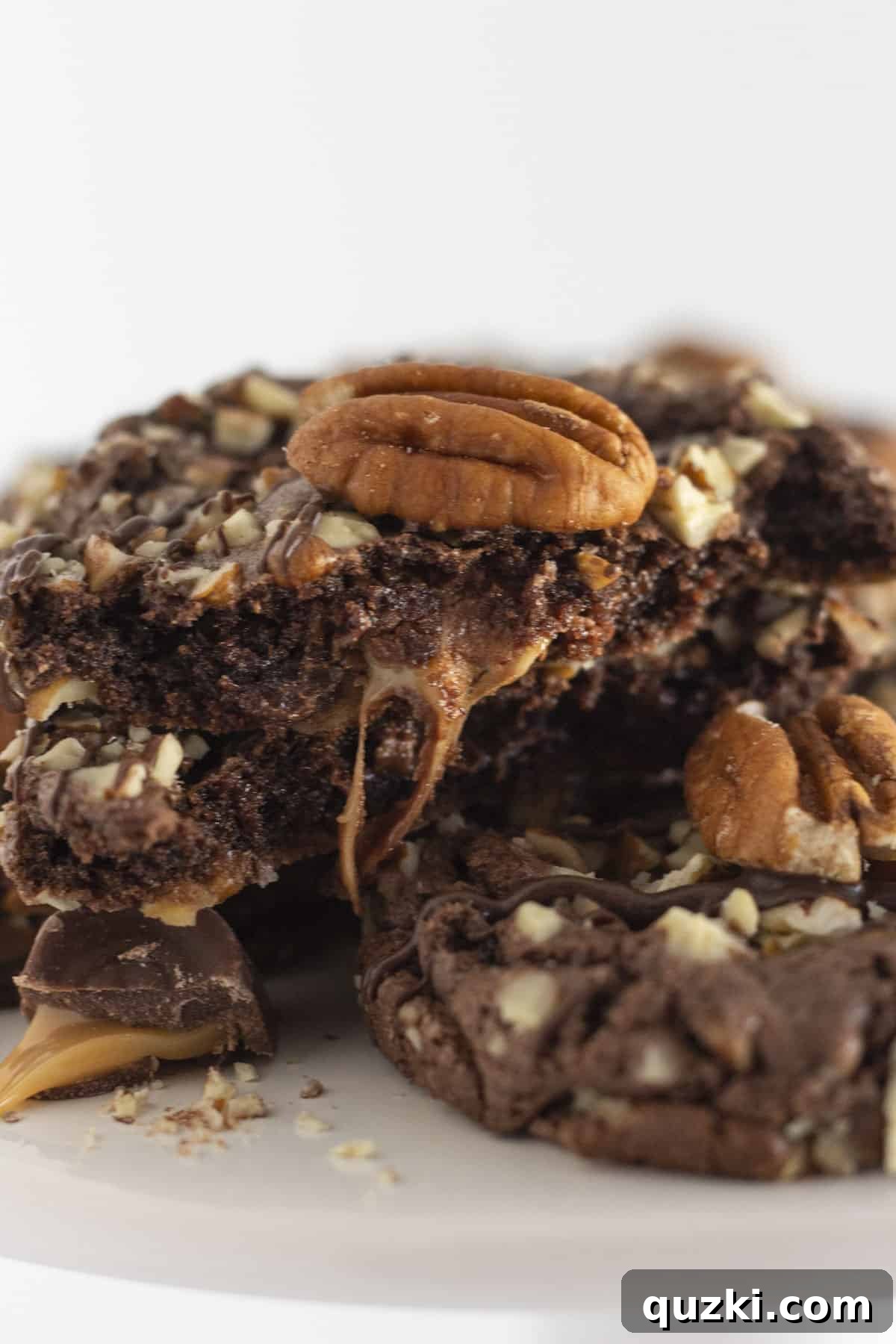 Simple Chocolate Pecan Turtle Cookies 7 A close-up view of turtle cookies, highlighting the creamy caramel oozing temptingly from the middle.