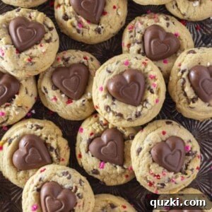 A tray full of Valentine's Chocolate Chip Cookies with heart sprinkles and a chocolate heart.