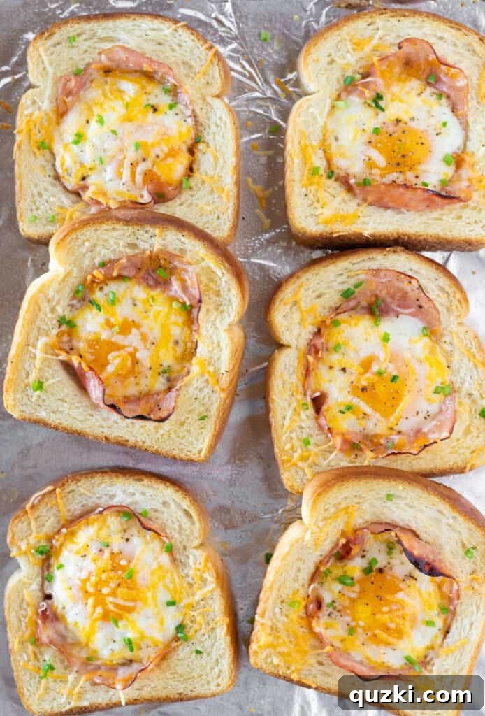 Close-up of a golden brown Sheet Pan Ham and Eggs in a Hole, showing the crisp bread and a glimpse of the ham cradling the egg, by Practically Homemade
