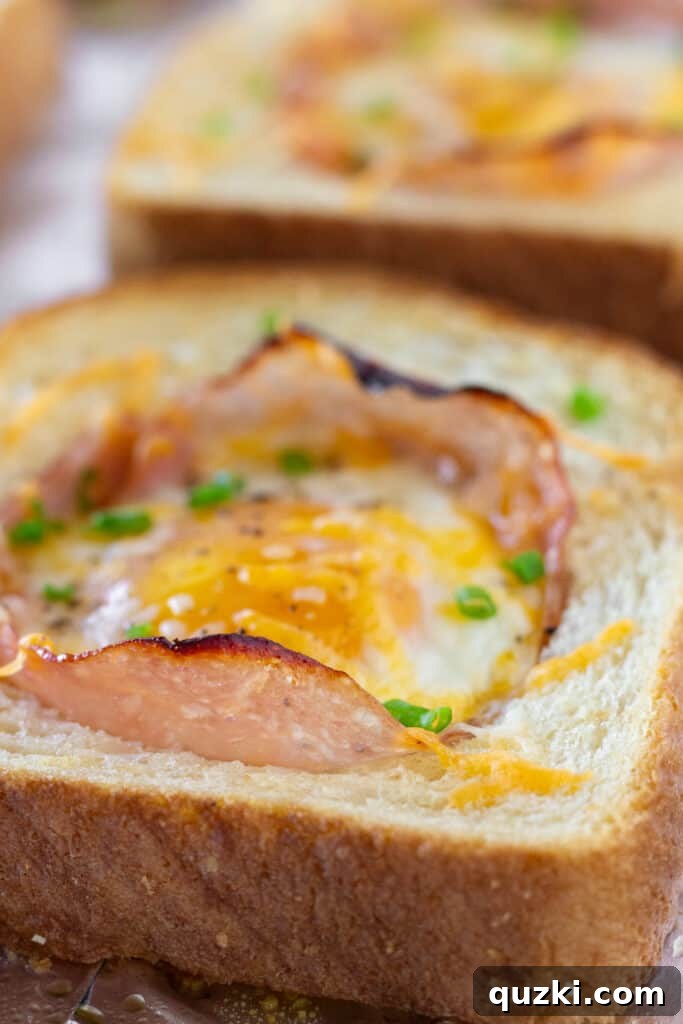 Sheet Pan Ham and Eggs in a Hole on a wooden cutting board, with a fork ready to enjoy, highlighting the delicious textures and golden crust