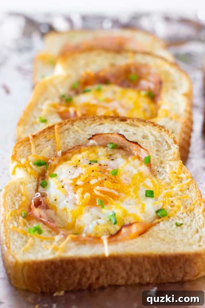 A close-up view of Sheet Pan Ham and Eggs in a Hole, showing the rich, vibrant colors and textures of the cooked egg, ham, and cheesy toast