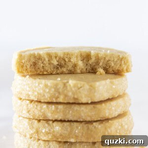 Five brown sugar shortbread cookies stacked on top of each other, showcasing their golden hue.